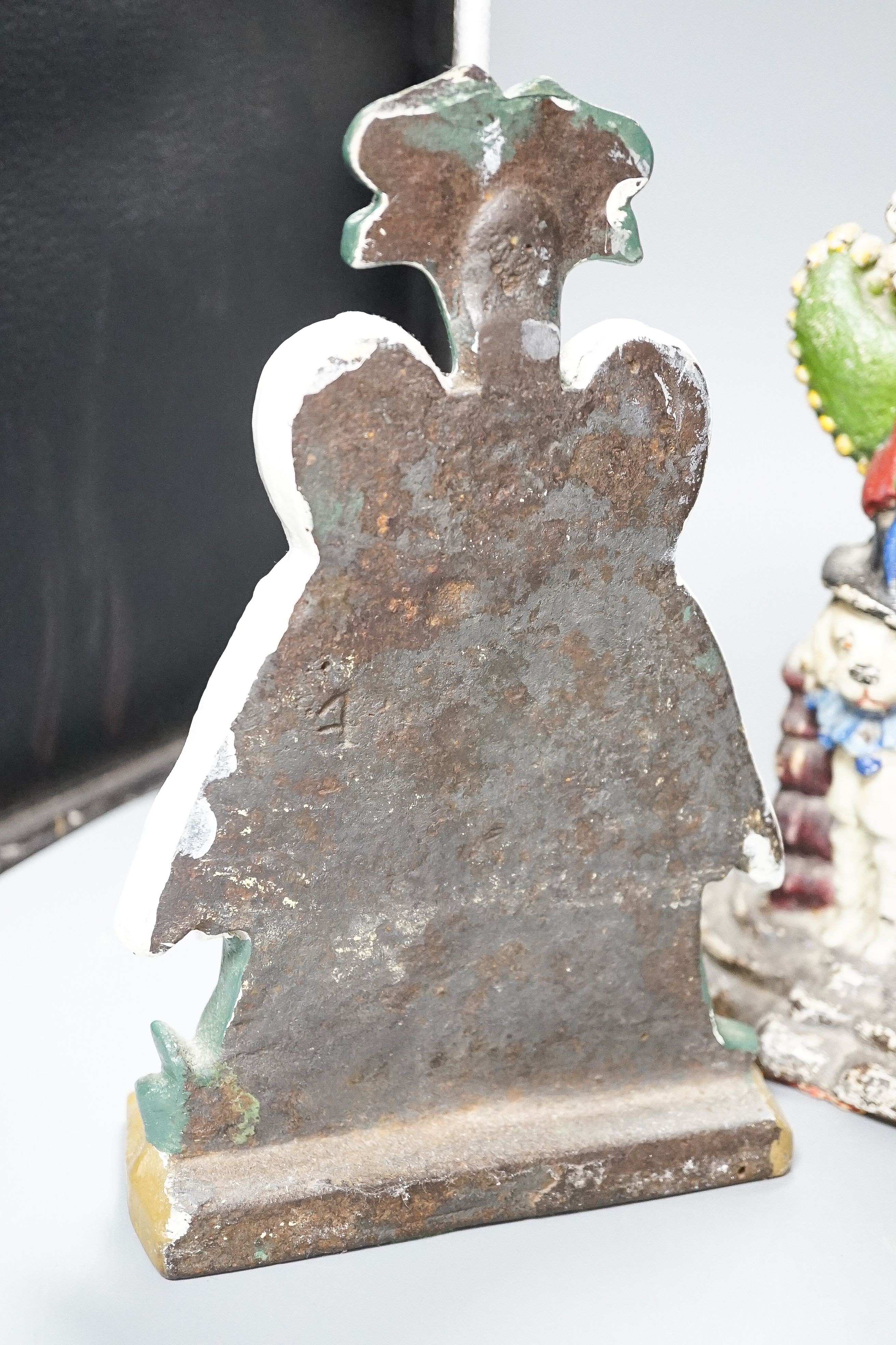Three Victorian painted cast iron door stops (re-painted) 31cm and a later figure